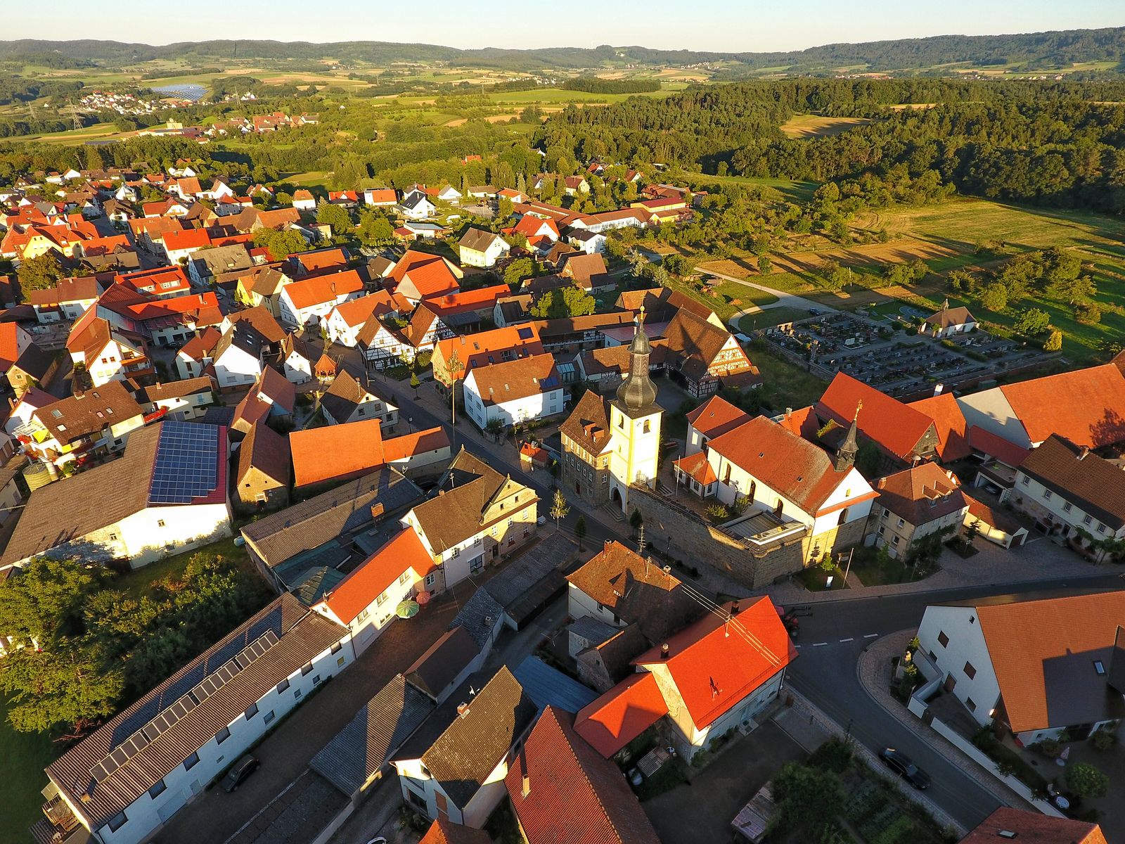 Pinzberg with its church in evening light, from the air