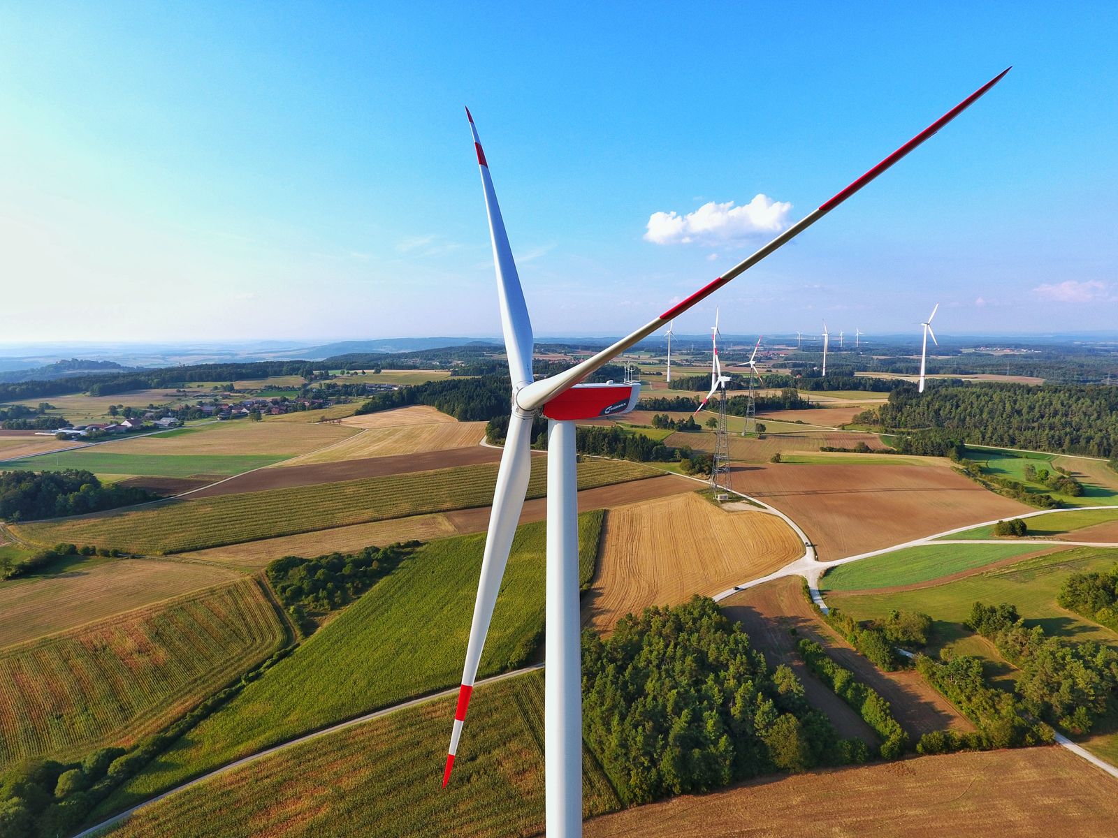 Wind turbine above the fields, from the air